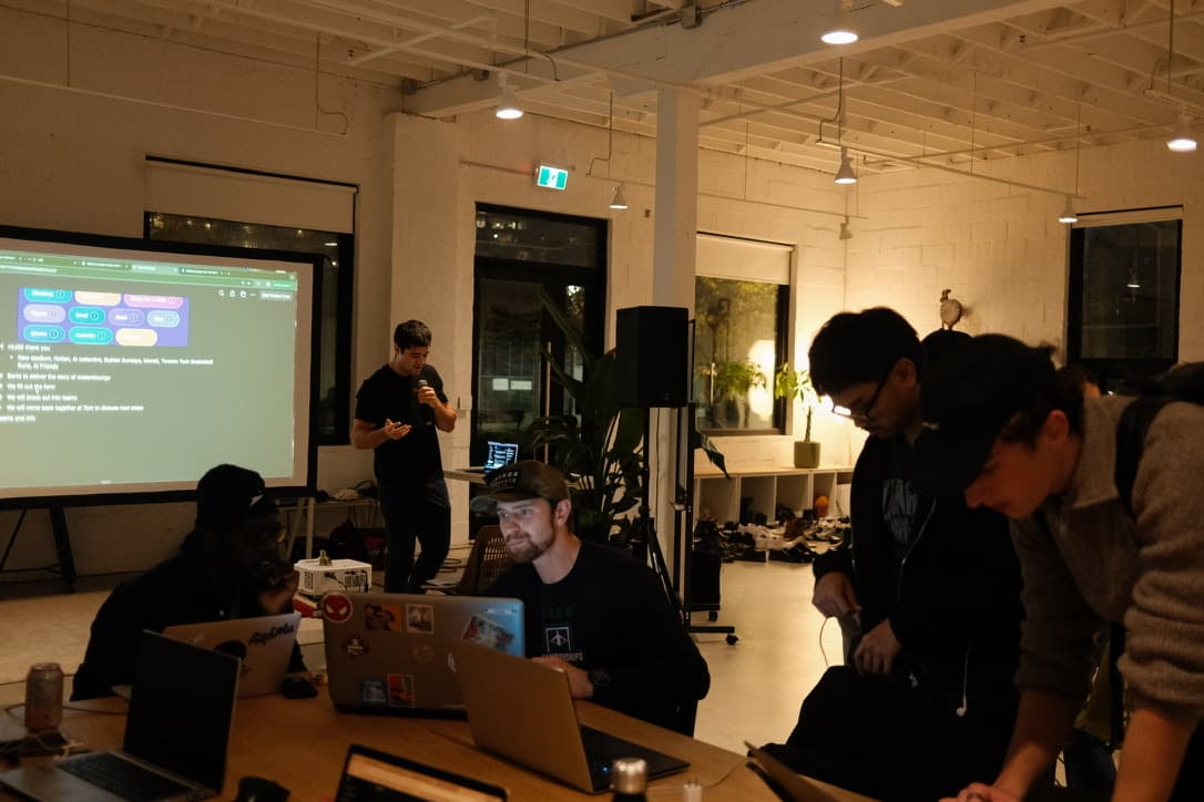 Teams heads-down at a hackathon